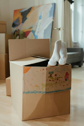 kid playfully being in a box